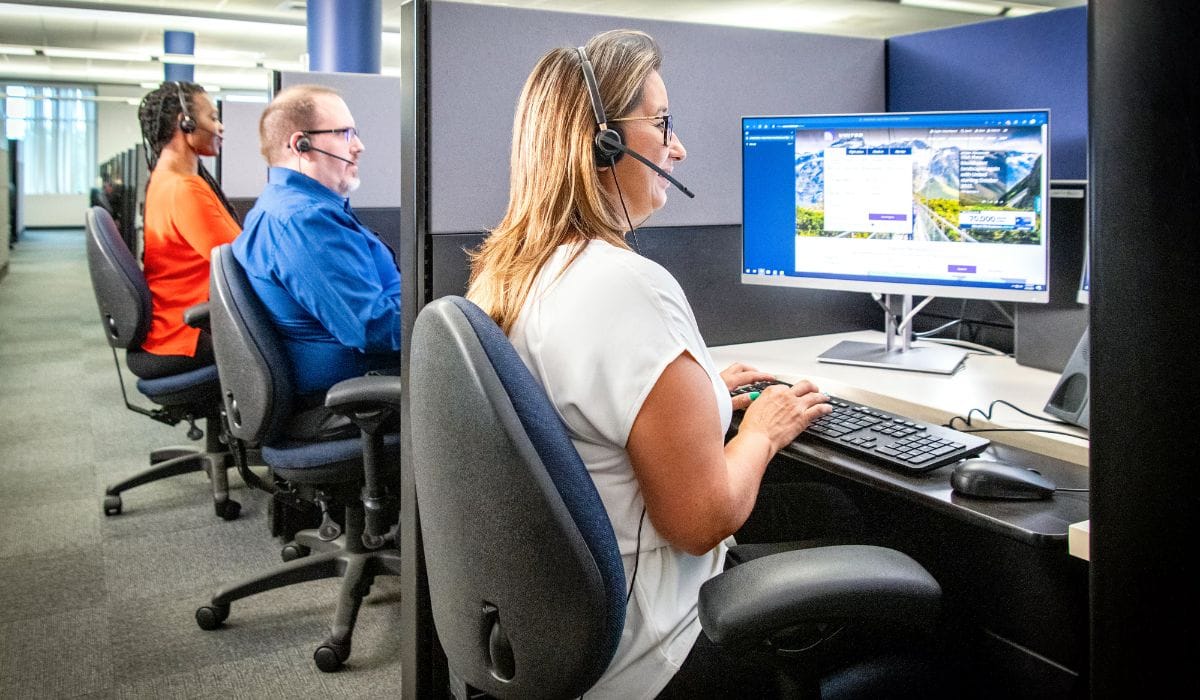 United Airlines reservation agents working at computer terminals in a customer service centre
